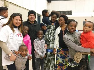 volunteers and refugees gather for a group photo