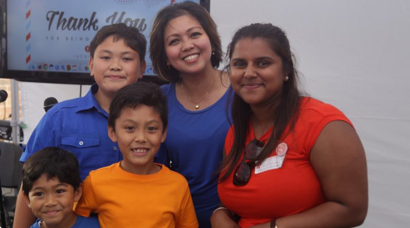 students with teacher smiling.