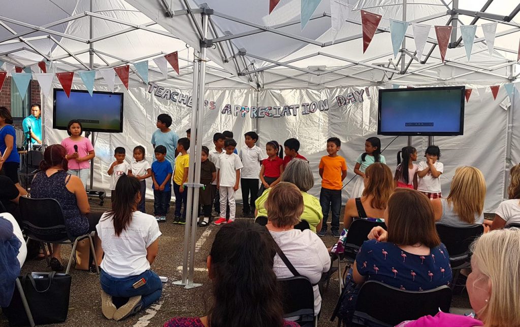 children performing for teachers