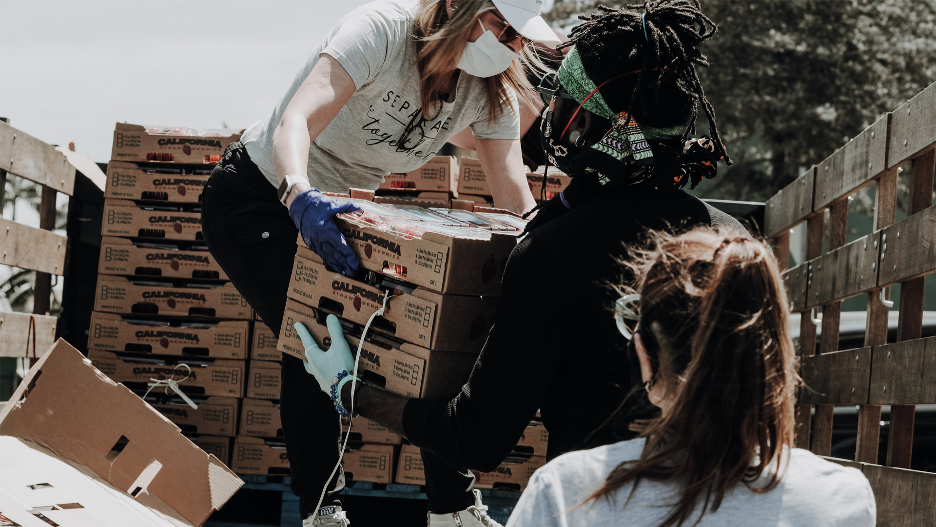 Volunteers unloading boxes of produce