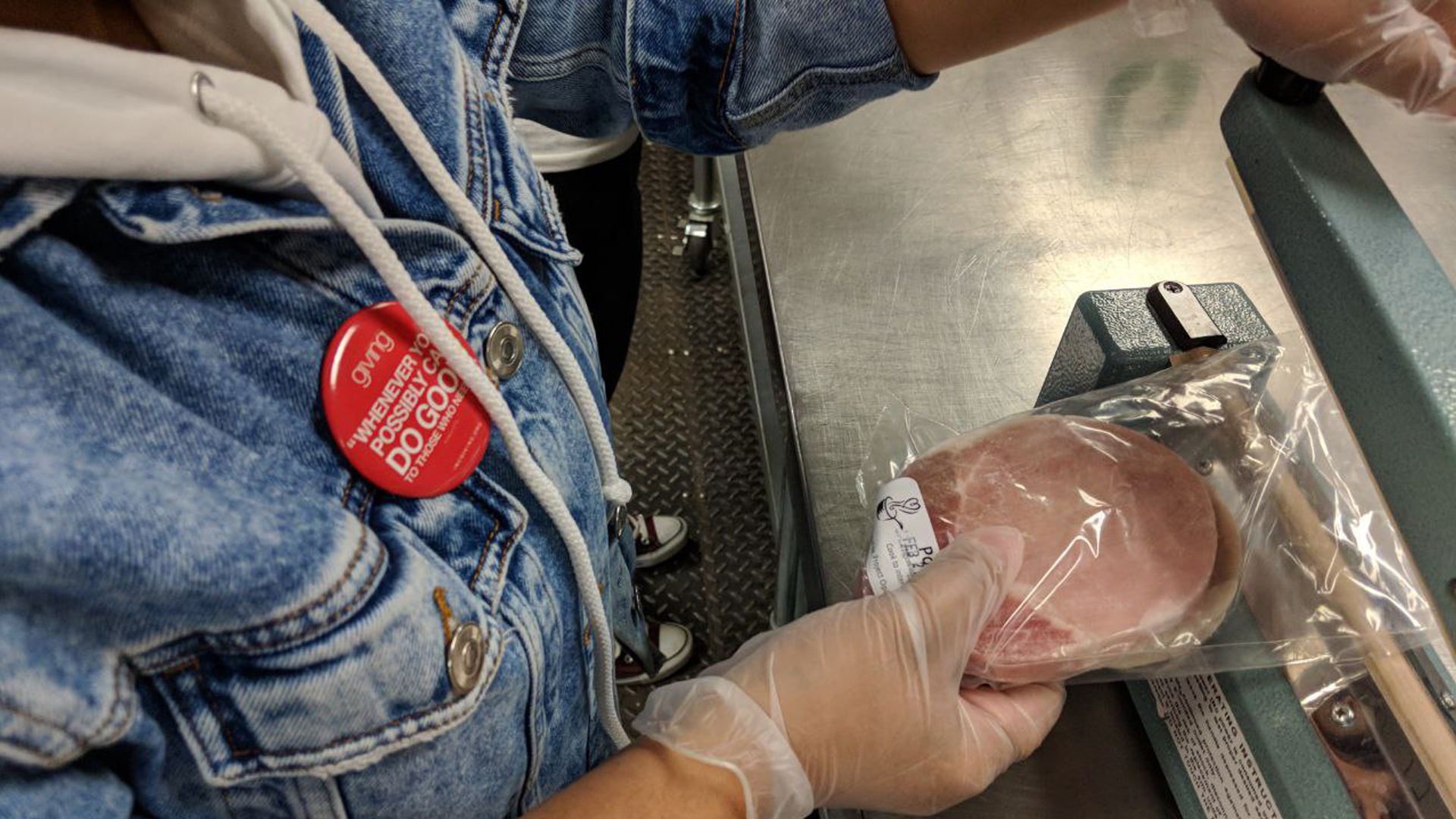 Volunteer holding a plastic bag with food ready to seal and pack